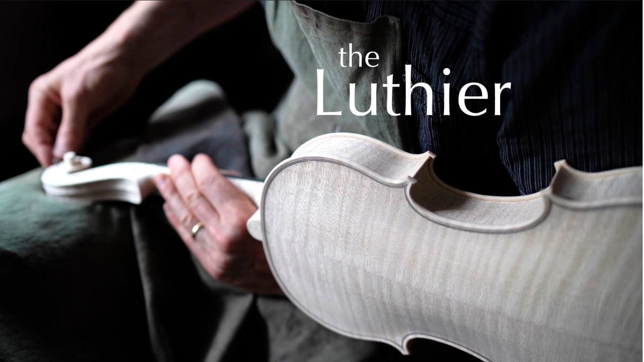 Film still from The Luthier: Andreas working by hand on an unfinished instrument